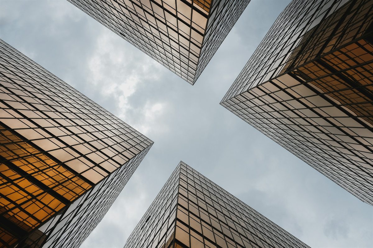 Gold-glass towers converging overhead in Hong Kong